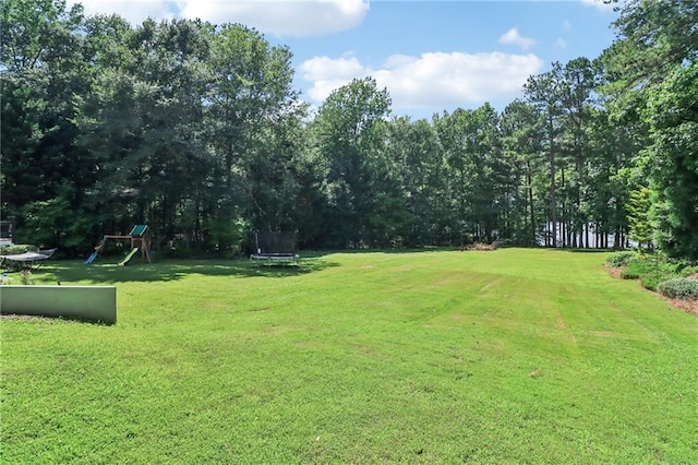 1213 Grande Vw, Loganville, GA 30052 - view of grassy yard featuring a trampoline