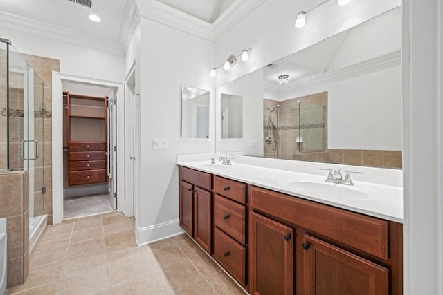 bathroom with vanity, tile patterned flooring, a shower with door, and crown molding