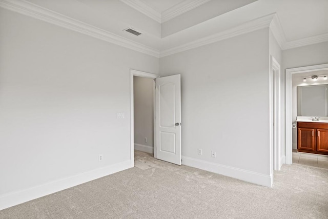 unfurnished room with ornamental molding, sink, and light colored carpet