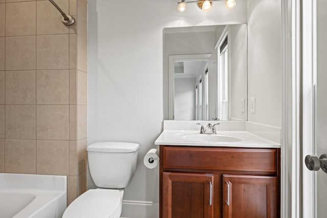 full bathroom with vanity, tiled shower / bath combo, and toilet