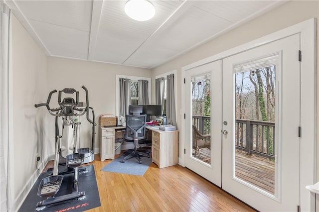 home office with light hardwood / wood-style flooring and french doors