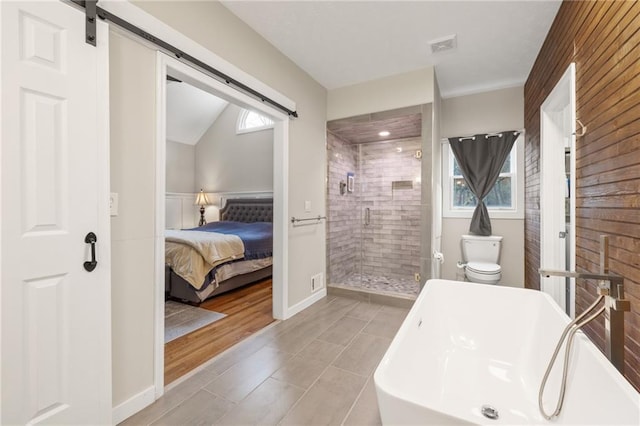 bathroom featuring plus walk in shower, hardwood / wood-style floors, toilet, and lofted ceiling