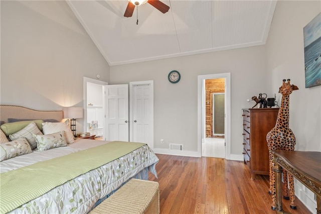 bedroom with wood-type flooring, high vaulted ceiling, and ceiling fan