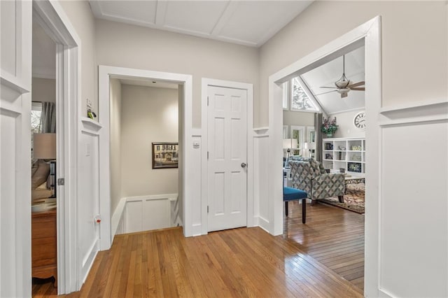 foyer featuring ceiling fan, lofted ceiling, and light hardwood / wood-style flooring