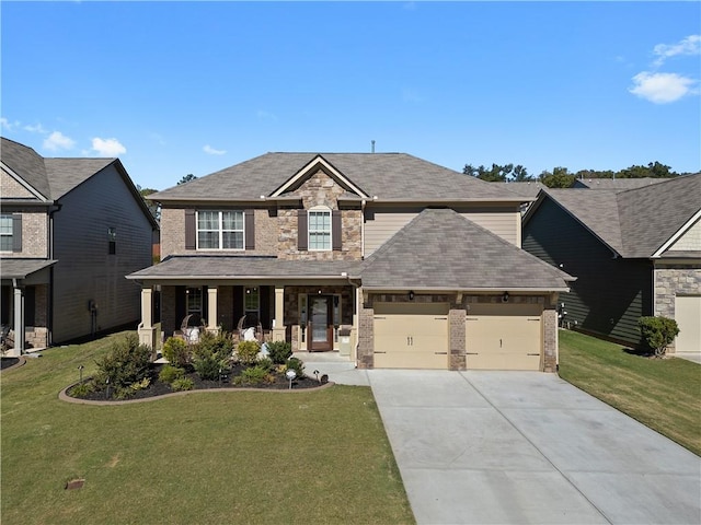 craftsman inspired home featuring covered porch, a garage, and a front lawn