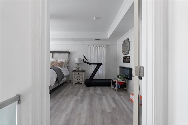 bedroom featuring ornamental molding and light hardwood / wood-style floors