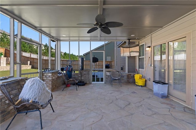 sunroom / solarium featuring ceiling fan