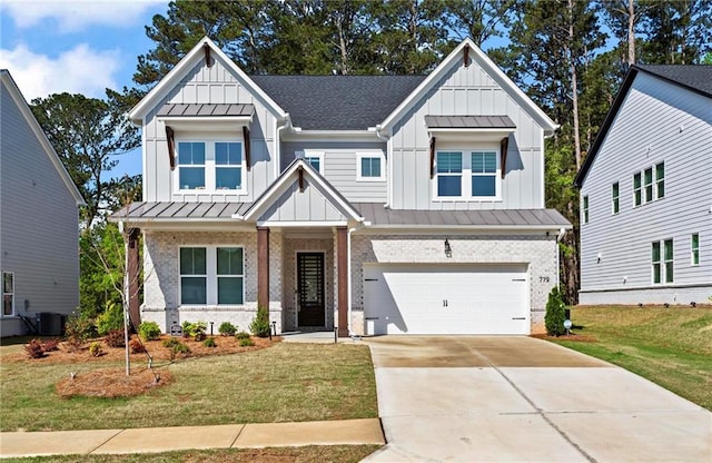view of front of home with board and batten siding, a standing seam roof, a front lawn, an attached garage, and driveway