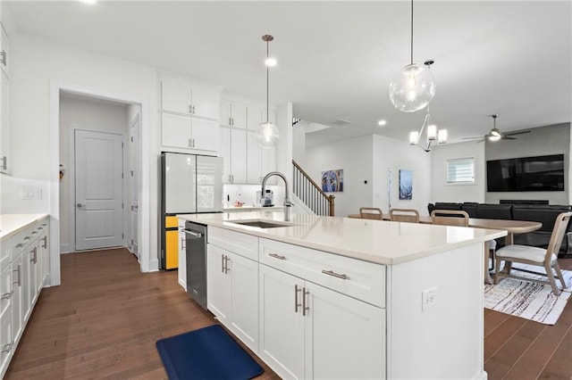 kitchen with white cabinetry, dark wood-type flooring, ceiling fan, dishwasher, and a sink
