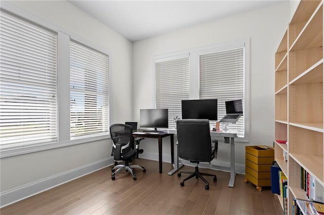 home office with baseboards and wood finished floors