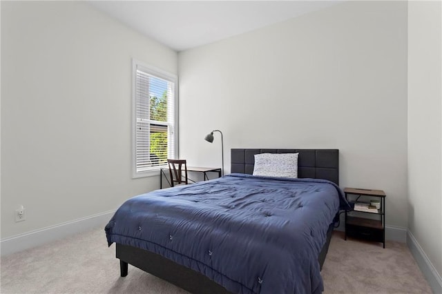 bedroom featuring baseboards and carpet