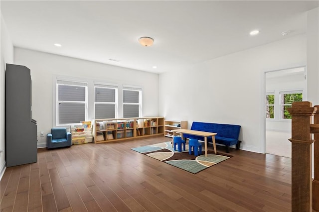 sitting room with baseboards, recessed lighting, and wood finished floors