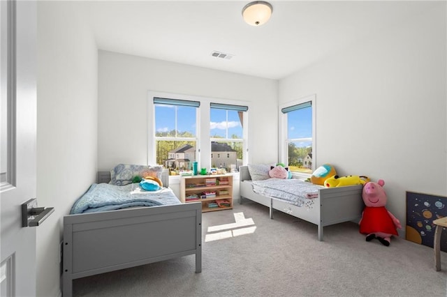 carpeted bedroom with visible vents
