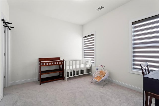 bedroom with baseboards, multiple windows, and carpet floors