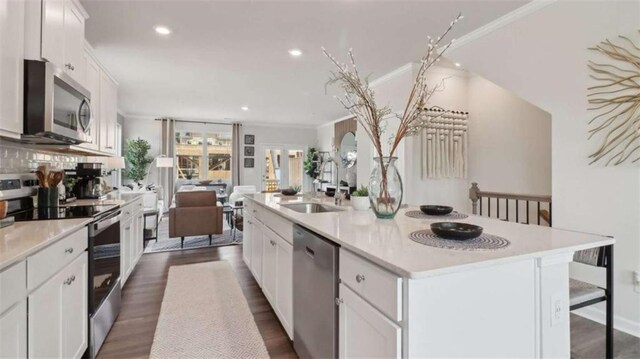 204 College Cir Unit 1003, Hapeville, GA 30354 - kitchen featuring white cabinetry, sink, dark hardwood / wood-style flooring, stainless steel appliances, and a center island with sink