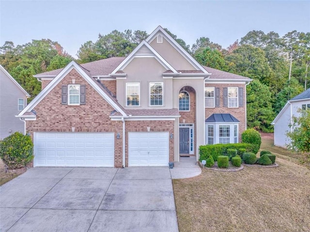 view of front of house featuring a garage, a front lawn, brick siding, and driveway