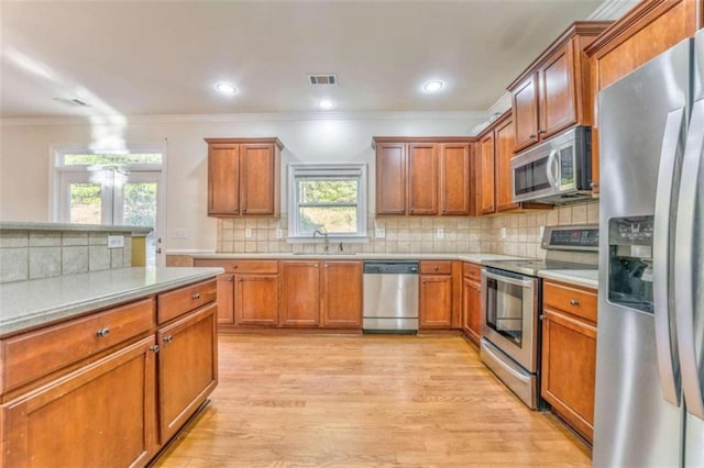 kitchen with visible vents, stainless steel appliances, light countertops, and a sink