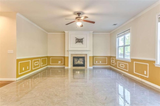unfurnished living room featuring crown molding, a decorative wall, marble finish floor, and ceiling fan