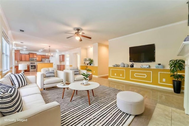 living area with visible vents, ornamental molding, a ceiling fan, light tile patterned floors, and baseboards