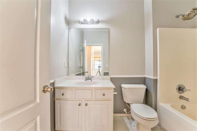 bathroom featuring shower / washtub combination, toilet, and vanity