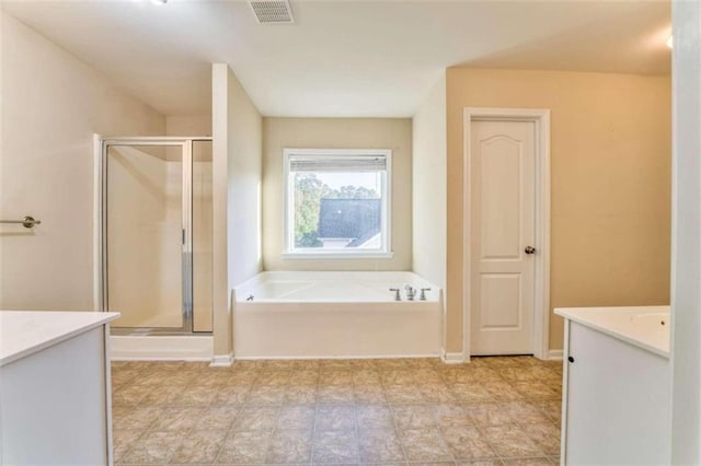 bathroom with visible vents, a shower stall, baseboards, a bath, and vanity