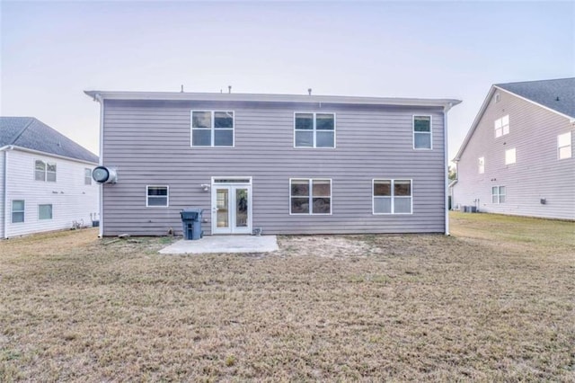 back of property featuring a patio area, french doors, and a yard