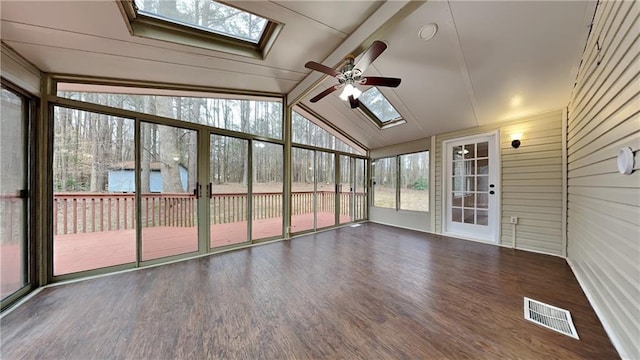 unfurnished sunroom with vaulted ceiling with skylight, visible vents, and a ceiling fan