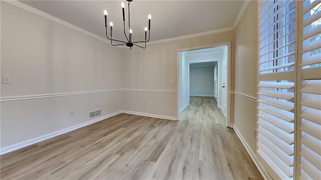 unfurnished dining area featuring visible vents, crown molding, baseboards, and wood finished floors