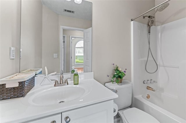 bathroom featuring toilet, vanity, and shower / bath combination