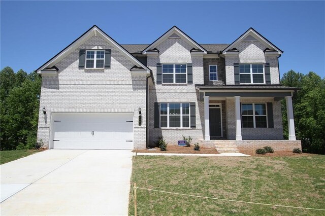 view of front of house featuring a front yard and a garage