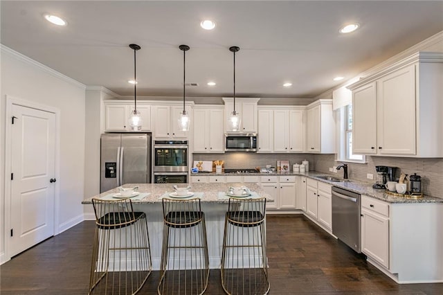 kitchen featuring appliances with stainless steel finishes, a kitchen breakfast bar, white cabinets, and dark hardwood / wood-style flooring