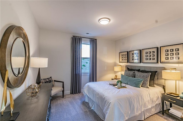 bedroom with dark colored carpet