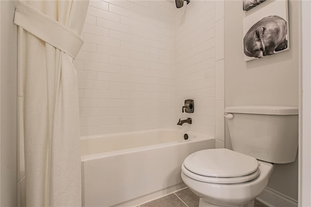 bathroom with tile floors, toilet, and shower / tub combo