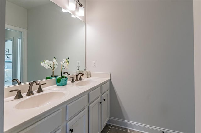 bathroom with double vanity and tile floors