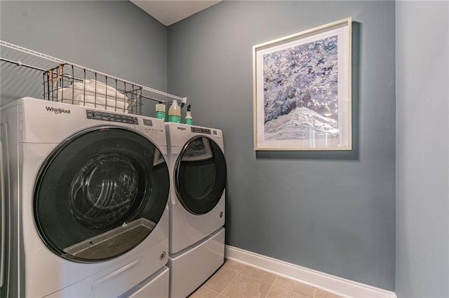 laundry area featuring independent washer and dryer and light tile floors