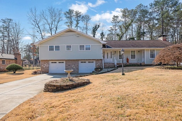 split level home featuring a garage and a front lawn