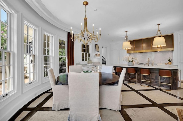 dining space with plenty of natural light, light tile flooring, a notable chandelier, and sink