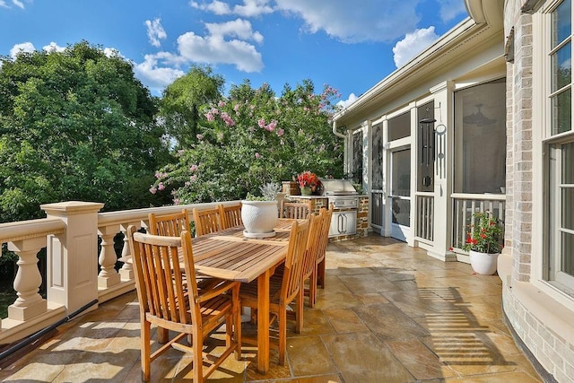 view of terrace featuring a grill and an outdoor kitchen