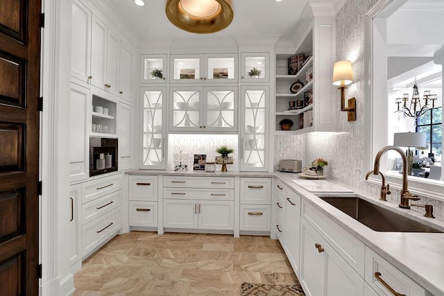 kitchen with light tile floors, white cabinets, backsplash, and sink