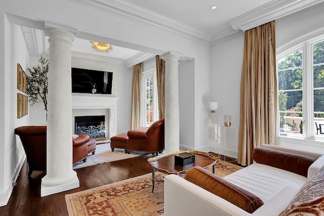 interior space featuring decorative columns, dark wood-type flooring, an inviting chandelier, and crown molding