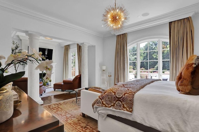 bedroom featuring light hardwood / wood-style flooring, decorative columns, ornamental molding, and a chandelier