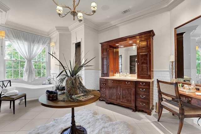 bathroom featuring vanity, a bathtub, an inviting chandelier, tile floors, and ornamental molding