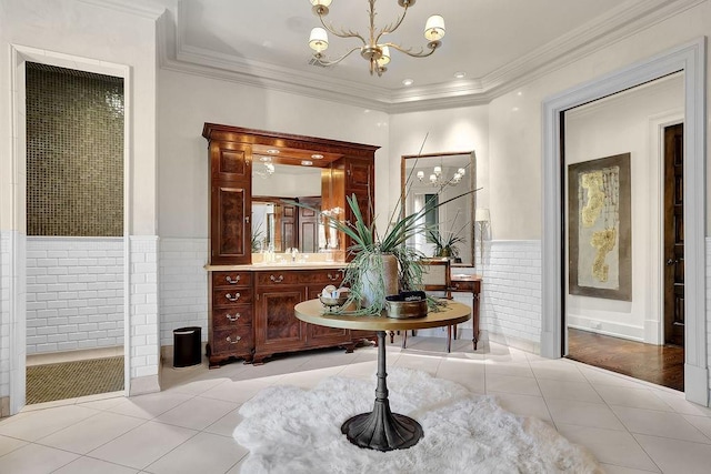 interior space featuring crown molding, a notable chandelier, vanity, wood-type flooring, and tile walls