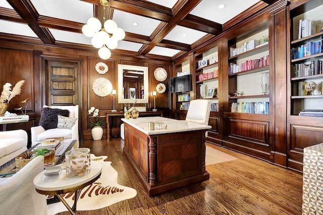 home office with a chandelier, built in shelves, coffered ceiling, and hardwood / wood-style flooring