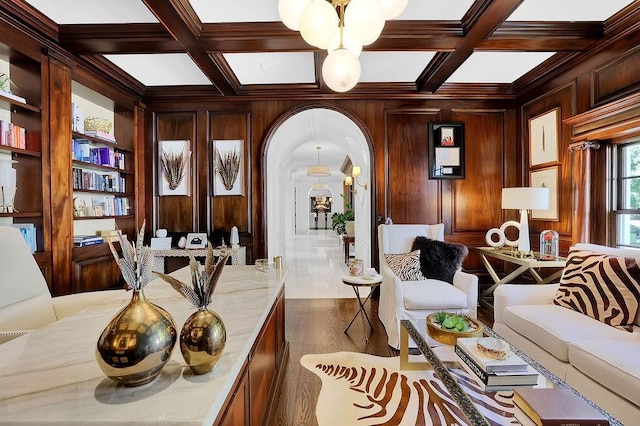 interior space with beam ceiling, coffered ceiling, wooden walls, and dark wood-type flooring