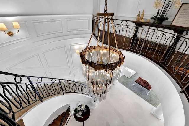 stairs featuring an inviting chandelier and tile floors