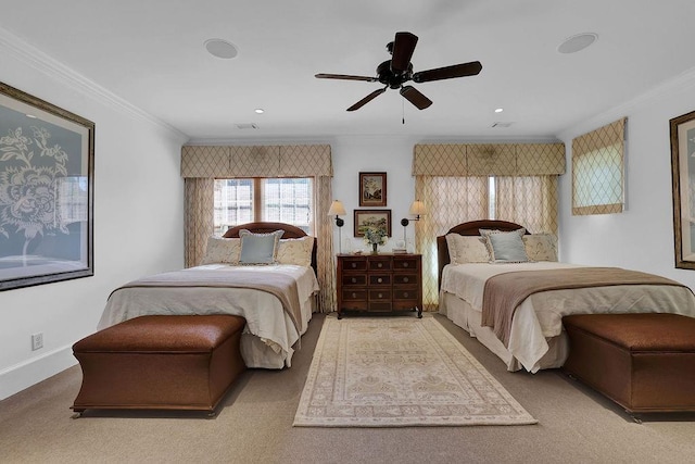 carpeted bedroom with ornamental molding and ceiling fan