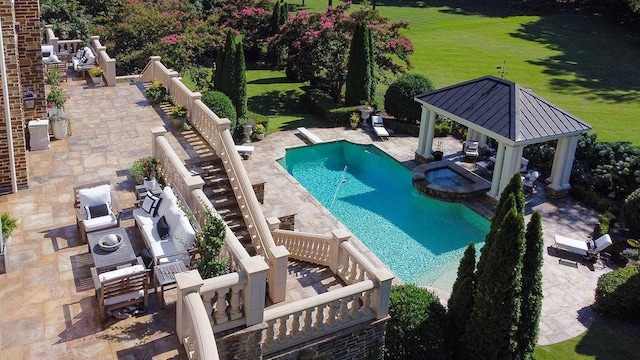 view of swimming pool with an in ground hot tub, a gazebo, a patio area, and a yard