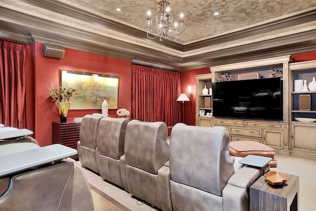 cinema room featuring crown molding, a chandelier, and a raised ceiling