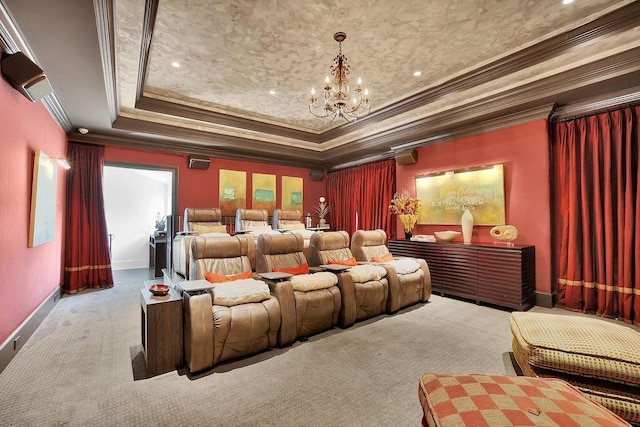 home theater room featuring a chandelier, a raised ceiling, ornamental molding, and light carpet